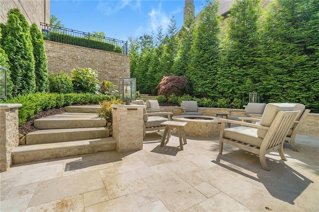 view of terrace with an outdoor fire pit