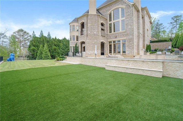 rear view of house with a yard and a patio