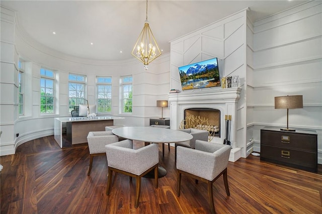 dining area featuring a chandelier, dark wood-type flooring, and crown molding