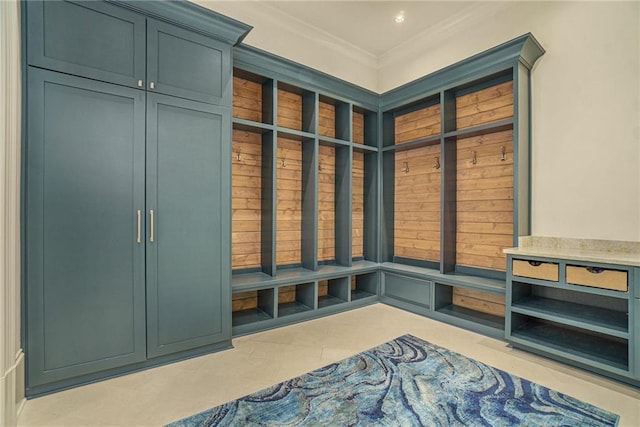 mudroom with light tile flooring and ornamental molding