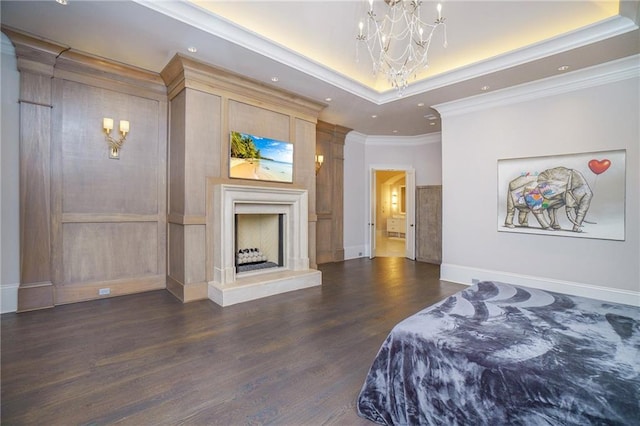 bedroom featuring a raised ceiling, ornamental molding, an inviting chandelier, and dark hardwood / wood-style flooring