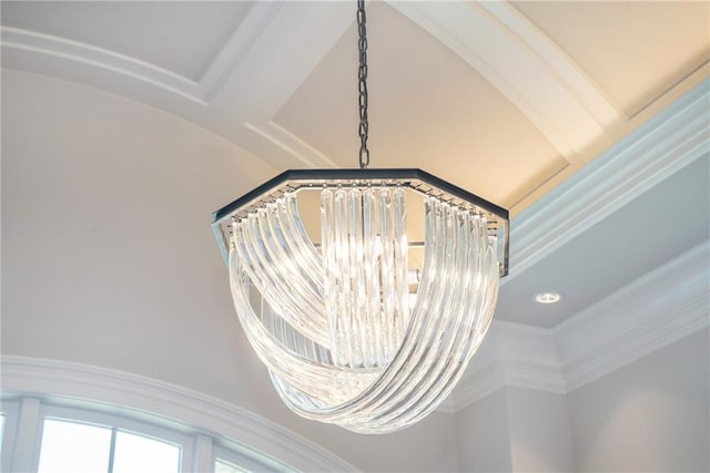 interior details featuring a chandelier and crown molding