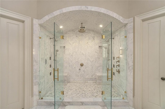 bathroom featuring a shower with shower door