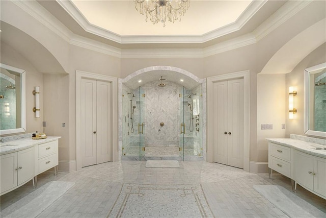 bathroom featuring a chandelier, a shower with door, vanity with extensive cabinet space, and tile flooring