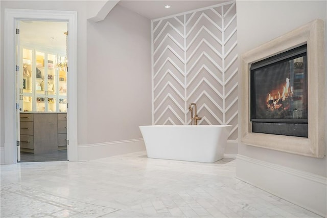 interior space featuring a tub, vanity, a chandelier, and tile flooring