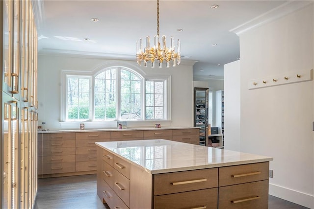 kitchen featuring an inviting chandelier, a kitchen island, ornamental molding, and dark hardwood / wood-style floors