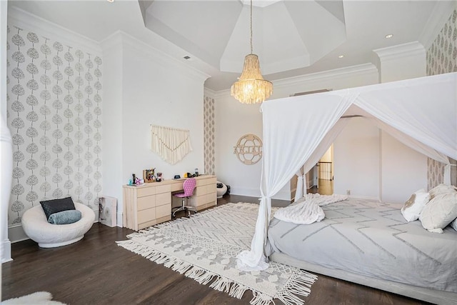 bedroom with a chandelier, dark hardwood / wood-style floors, a raised ceiling, and ornamental molding