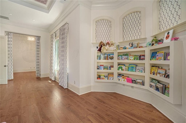 playroom with crown molding and dark hardwood / wood-style flooring