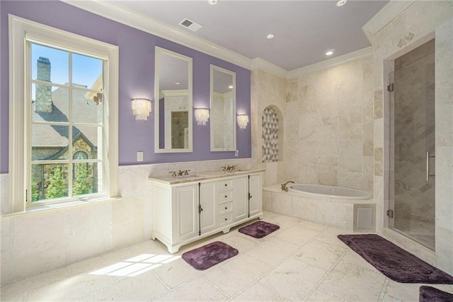 bathroom featuring ornamental molding, tile floors, double vanity, and separate shower and tub