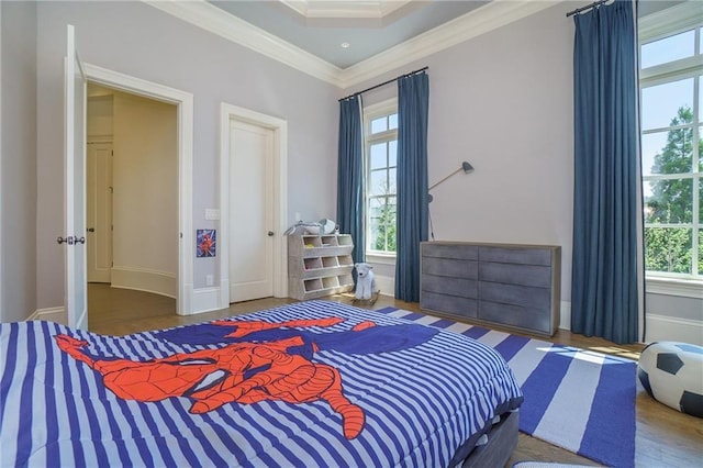 bedroom featuring crown molding, dark wood-type flooring, and multiple windows