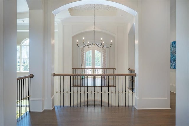 hall featuring a chandelier and dark hardwood / wood-style floors