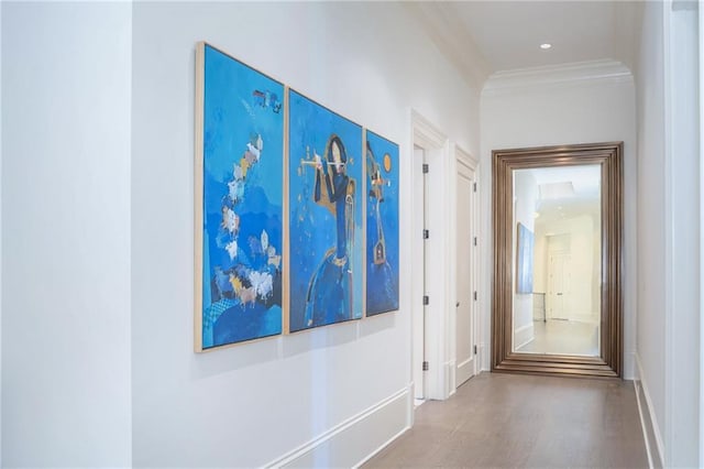 corridor featuring ornamental molding and light wood-type flooring