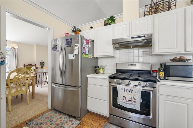 3485 Palisade Lake Dr, Duluth, GA 30096 - kitchen with stainless steel appliances, under cabinet range hood, light countertops, white cabinetry, and ornamental molding