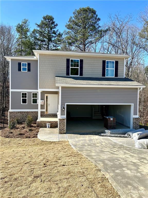 view of front of home with a front lawn and a garage