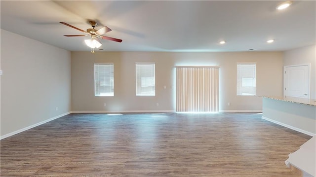 unfurnished living room featuring hardwood / wood-style flooring and ceiling fan