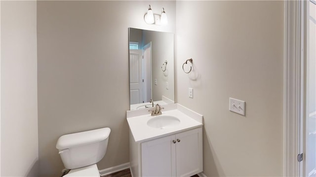 bathroom featuring toilet and vanity