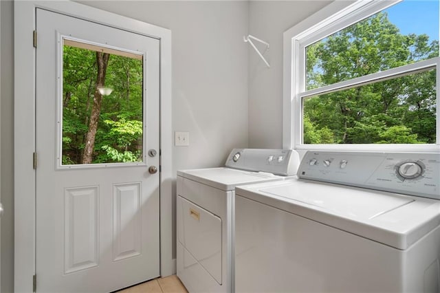 washroom with light tile patterned flooring and washing machine and clothes dryer