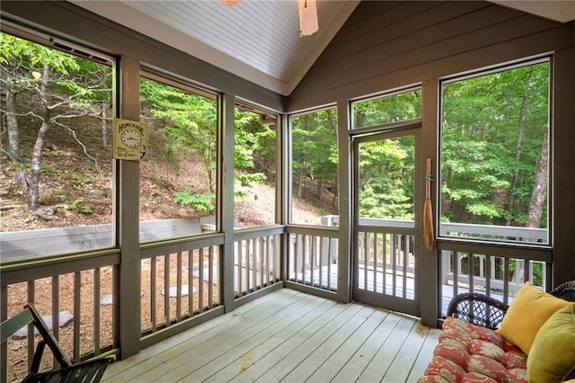 unfurnished sunroom featuring ceiling fan and lofted ceiling