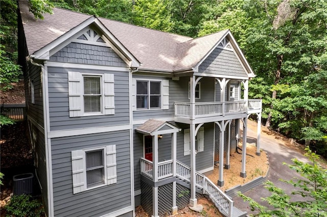 view of front of property featuring central AC unit and a balcony