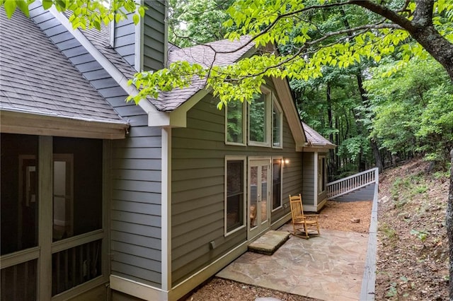 view of property exterior with a patio area