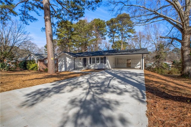 view of front of house with an attached carport and concrete driveway