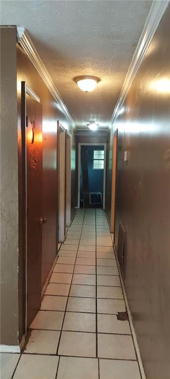 hallway featuring crown molding, tile patterned flooring, and a textured ceiling