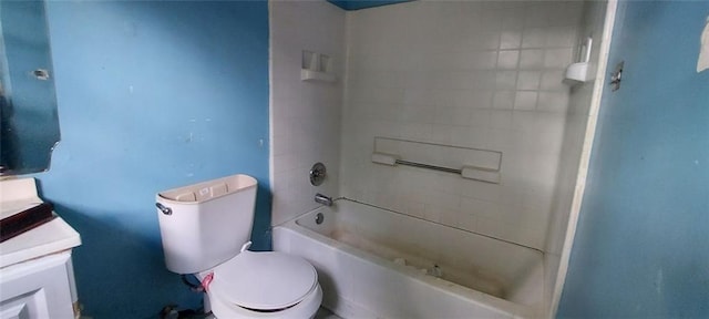 full bathroom featuring tiled shower / bath, vanity, and toilet