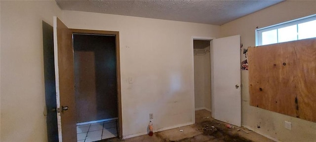 unfurnished bedroom with a closet and a textured ceiling