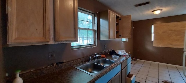 kitchen featuring sink and light tile patterned floors