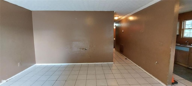 spare room with sink and ornamental molding