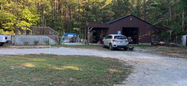 exterior space featuring a carport and an outbuilding