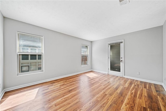 717 Beaufort Cir, Duluth, GA 30096 - unfurnished room featuring a textured ceiling, wood finished floors, and baseboards