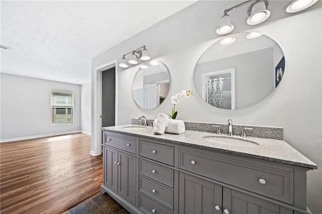 717 Beaufort Cir, Duluth, GA 30096 - full bath with double vanity, baseboards, and a textured ceiling