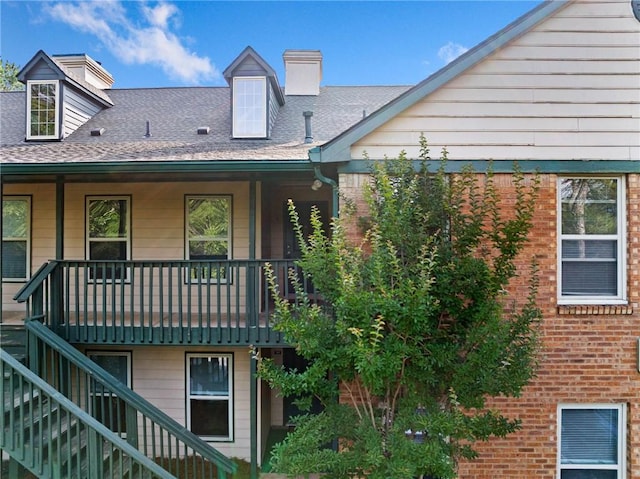 717 Beaufort Cir, Duluth, GA 30096 - back of property featuring stairs, brick siding, and a chimney
