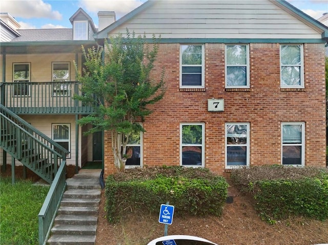 717 Beaufort Cir, Duluth, GA 30096 - view of front facade featuring stairs, brick siding, and a chimney