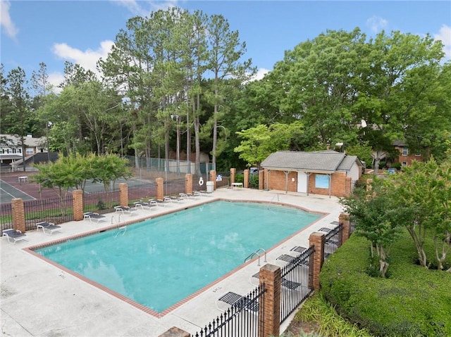 717 Beaufort Cir, Duluth, GA 30096 - community pool featuring a patio area and view of wooded area