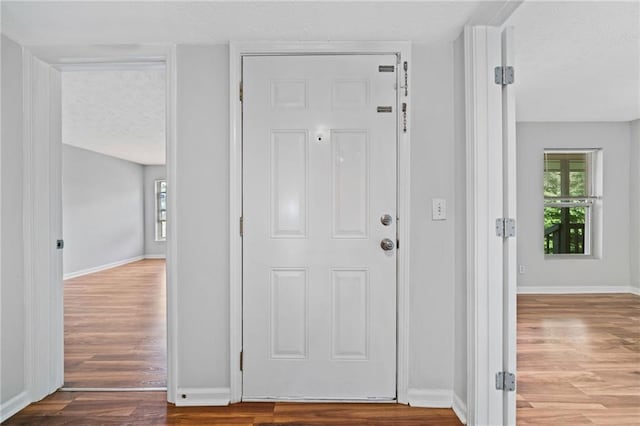 717 Beaufort Cir, Duluth, GA 30096 - entryway with wood finished floors, healthy amount of natural light, baseboards, and a textured ceiling