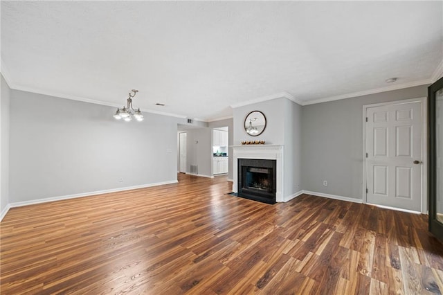 717 Beaufort Cir, Duluth, GA 30096 - unfurnished living room with a chandelier, wood finished floors, baseboards, a fireplace with flush hearth, and crown molding