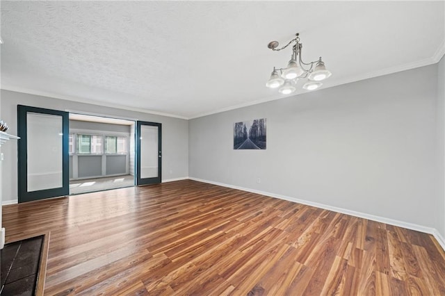 717 Beaufort Cir, Duluth, GA 30096 - unfurnished room with baseboards, wood finished floors, ornamental molding, and a chandelier