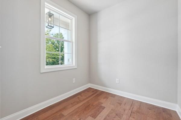 empty room with hardwood / wood-style flooring