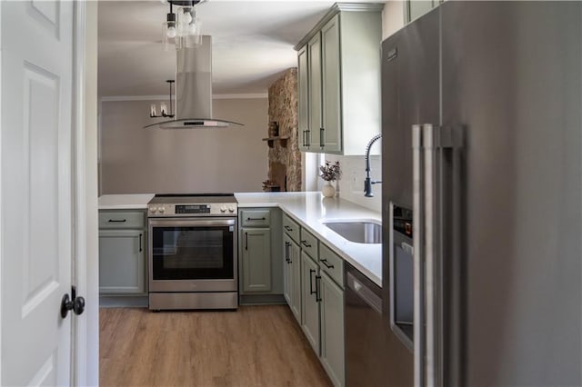 kitchen with crown molding, gray cabinets, island exhaust hood, stainless steel appliances, and a sink