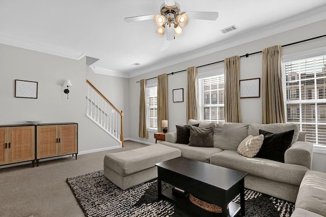 carpeted living room featuring plenty of natural light, ceiling fan, and crown molding