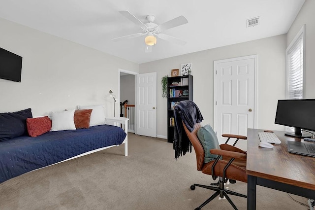 bedroom with ceiling fan and light carpet