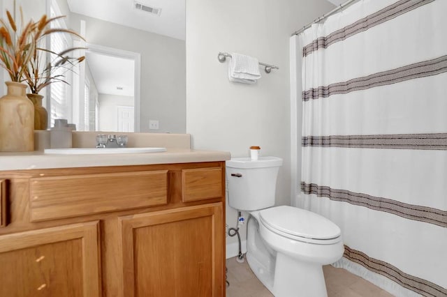 bathroom featuring tile patterned floors, vanity, and toilet