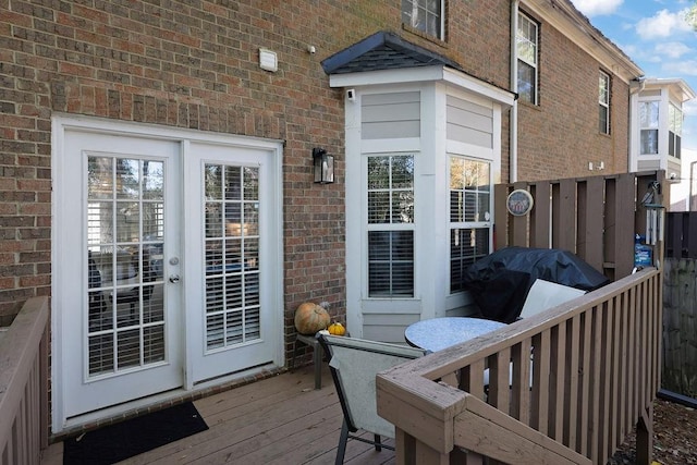 wooden deck featuring a grill