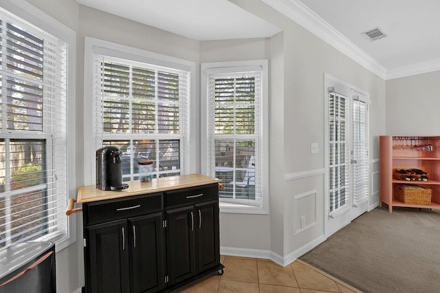 interior space with light colored carpet and crown molding