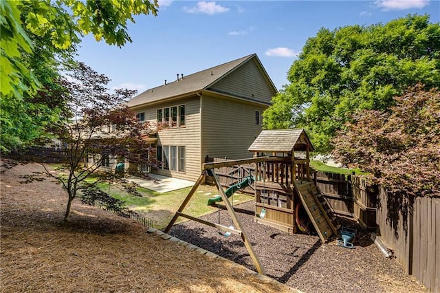1725 Lynwood Pl, Alpharetta, GA 30004 - back of house featuring a playground, a fenced backyard, and a patio