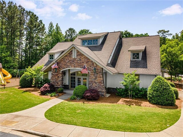 1725 Lynwood Pl, Alpharetta, GA 30004 - view of front facade with french doors, stone siding, a shingled roof, and a playground