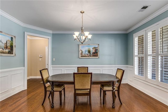 1725 Lynwood Pl, Alpharetta, GA 30004 - dining area featuring a chandelier, dark wood-style flooring, healthy amount of natural light, crown molding, and a wainscoted wall