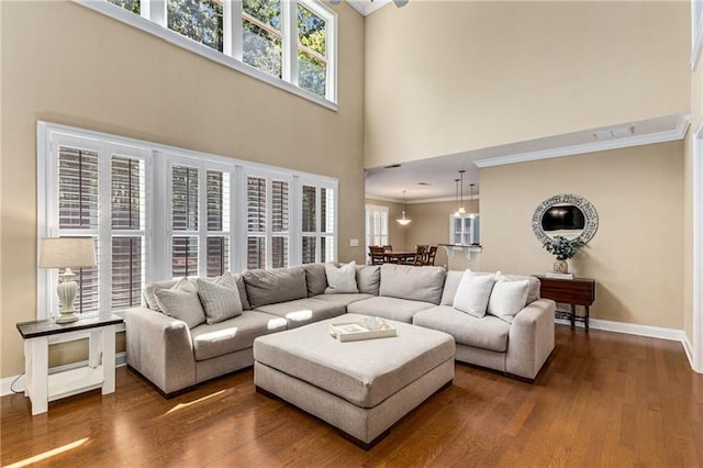1725 Lynwood Pl, Alpharetta, GA 30004 - living area featuring a high ceiling, crown molding, wood finished floors, and baseboards